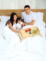 Obraz na płótnie Canvas Smiling family having breakfast
