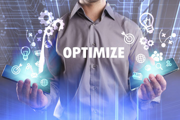 Business, Technology, Internet and network concept. Young businessman working on a virtual screen of the future and sees the inscription: Optimize