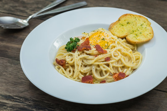 Spaghetti carbonara with egg yolk on plate