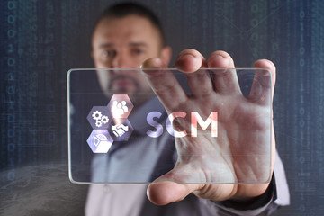 Business, Technology, Internet and network concept. Young businessman working on a virtual screen of the future and sees the inscription: SCM