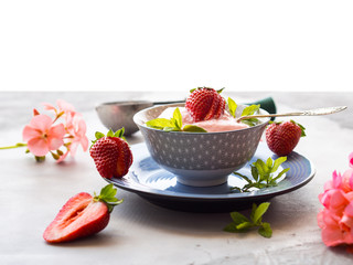 Home made strawberry ice cream in bowl with min leaves