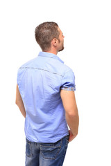 Young man from the back - looking at something over a white back