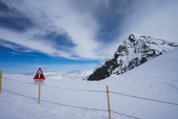 View from Jungfraujoch, Switzerland in the blue sky sunny day, Top of Europe, Fence and caution sign on the observation desk of Jungfrau