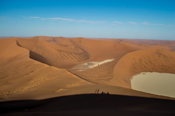 Climbing Big Daddy Dune, Desert Landscape with People Shadows, Looking onto Sossusvlei Salt Pan, Namibia