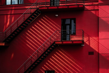 red building with stairs and shadows