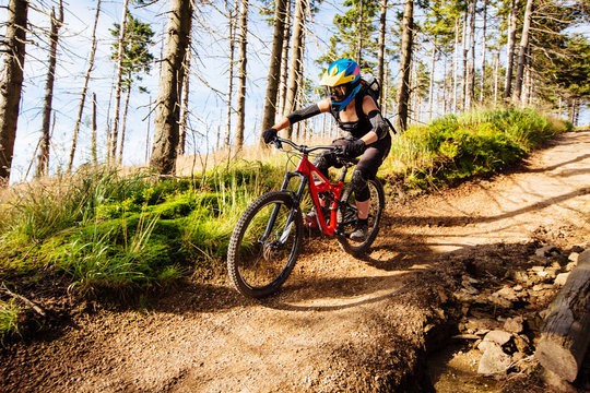 Picture of young woman riding mtb mountain bike, downhill
