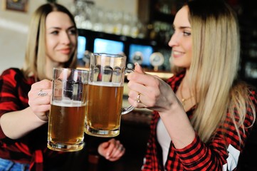 Company friends drink beer and smile