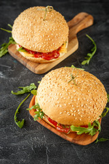 Homemade burger with arugula, tomato and cheese