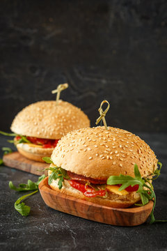 Homemade burger with arugula, tomato and cheese