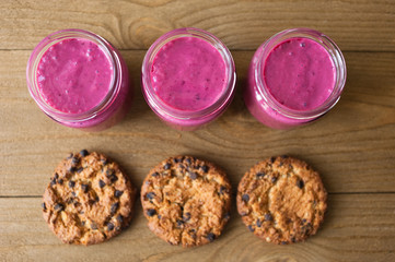 Cookies on rustic wooden  table. Chocolate dessert with berry fresh smoothie.