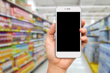 Fototapeta na wymiar Hand holding White Smartphone for online shopping concept