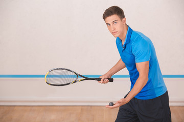 Young man squash player exercise game in the gym