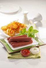 beef franks with mayonnaise ketchup and fries
