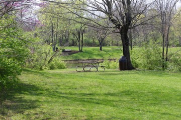 The empty picnic table overlooking the lake in the park.