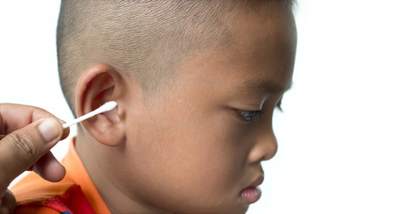Mother hand cleaning child ear with cotton swab