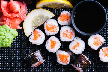 Sushi rolls with salmon, ginger and lemon slice 