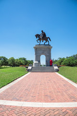 Graduated student takes photo at statue of Sam Houston in Hermann Park, Houston. An American...