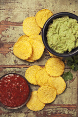 Mexican nachos chips with homemade fresh guacomole sauce and salsa