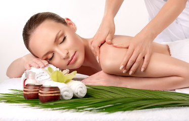 Naklejka na ściany i meble Body care. Spa body massage treatment. Woman having massage in the spa salon