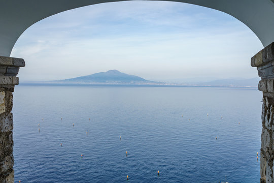 View of Vesuvio volcano with beautiful blue sea and sky in the sunset, southern Italy