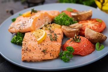 Baked salmon fish fillet with tomatoes, mushrooms and spices. Diet menu.