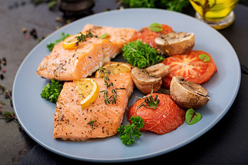 Baked salmon fish fillet with tomatoes, mushrooms and spices. Diet menu. © timolina