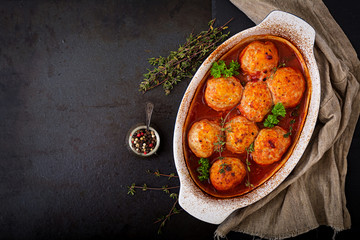 Baked meatballs of chicken fillet in tomato sauce. Flat lay. Top view