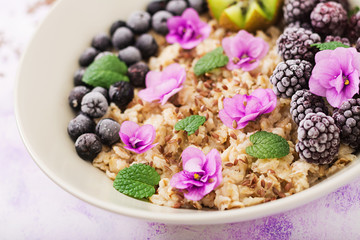 Tasty and healthy oatmeal porridge with fruit, berry and flax seeds. Healthy breakfast. Fitness food. Proper nutrition.