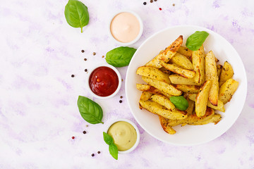 Ruddy Baked potato wedges with  herbs on a light background. Flat lay. Top view.