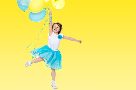 Little girl with multicolored balloons.