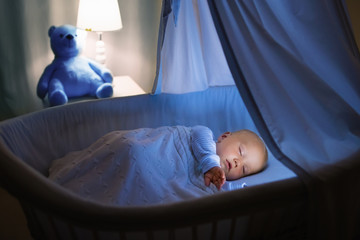 Baby boy drinking milk in bed
