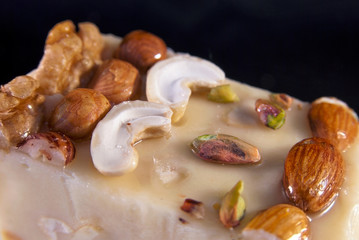 Sherbet with different nuts on the black background