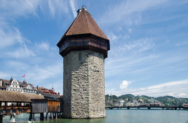 Fototapeta na wymiar Water Tower and Chapel Bridge (Kapellbrucke) - covered wooden footbridge in Lucerne, Switzerland