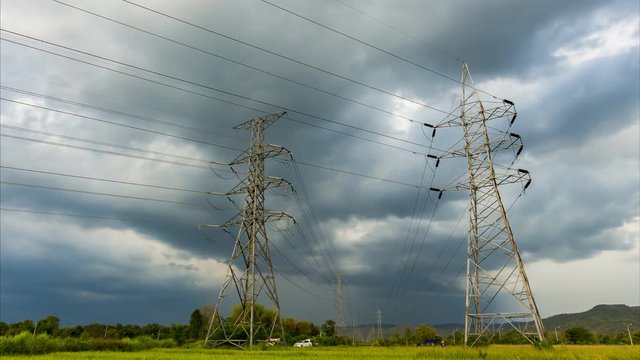 Time Lapse of Dramatic sky with stormy clouds before rain and high voltage pole.