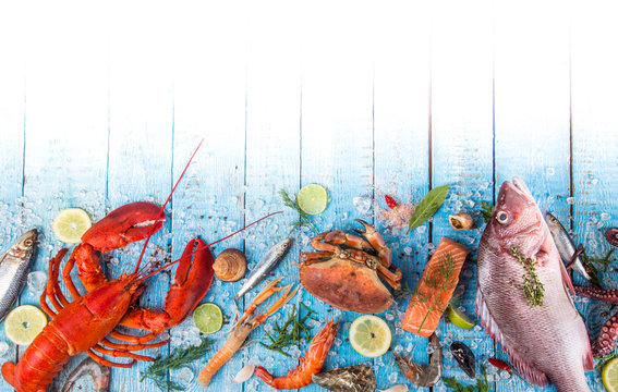 Fresh tasty seafood served on old wooden table.