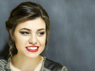 Young beautiful girl with makeup. Portrait on a blue background