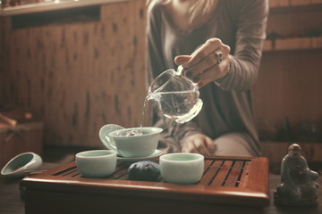 young beautiful blonde woman making tea ceremony