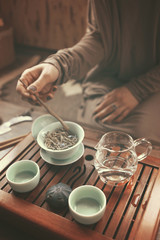 Fototapeta na wymiar young beautiful blonde woman making tea ceremony