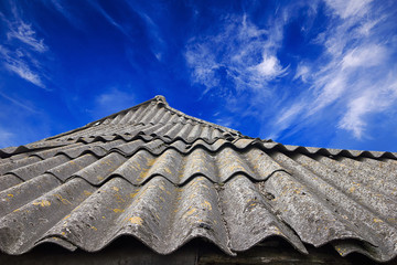 Vintage natural tile roof on the blue sky background 