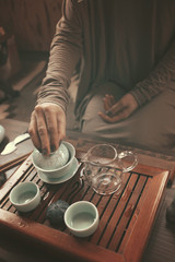 Obraz na płótnie Canvas young beautiful blonde woman making tea ceremony