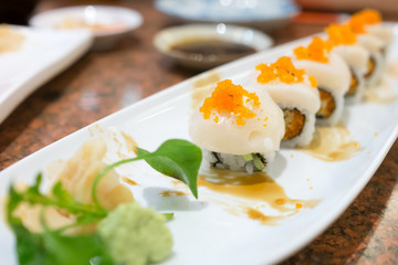 Roll sushi with scallop on top