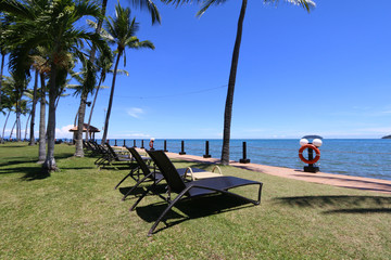 Tropical island vacation with deck chairs by seaside
