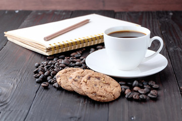 Coffee cup and coffee beans on wooden background