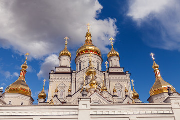 orthodox church with golden domes, Trinity cathedral and bell tower in Pochaev Lavra (Pochayiv Lavra), Ukraine