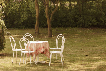 Vintage looking chairs and round table in park