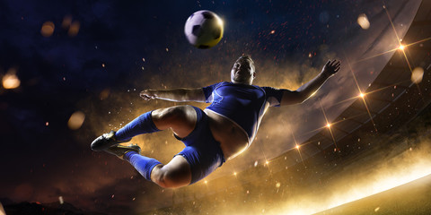 fat soccer player in action. stadium in fire night
