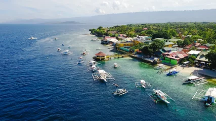 Fototapeten Aerial view of sandy beach with tourists swimming in beautiful clear sea water of the Sumilon island beach landing near Oslob, Cebu, Philippines. - Boost up color Processing. © tirachard