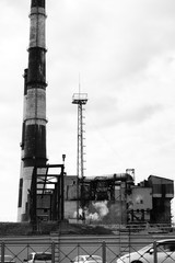The factory in the industrial zone, two tall chimneys, black and white