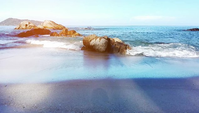 Motion of water wave in the sea landscape nature and bech sand with sky in morning light