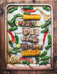 Tasty grill plate with roasted Meat skewers with vegetables and roasted corn ears, top view